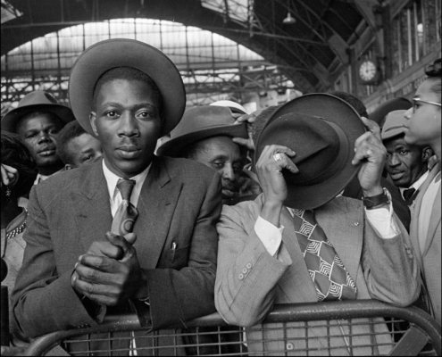 Black and white original photo of the Windrush men arriving into Waterlook station in their smart suits and hats. Image copyright: Getty Images